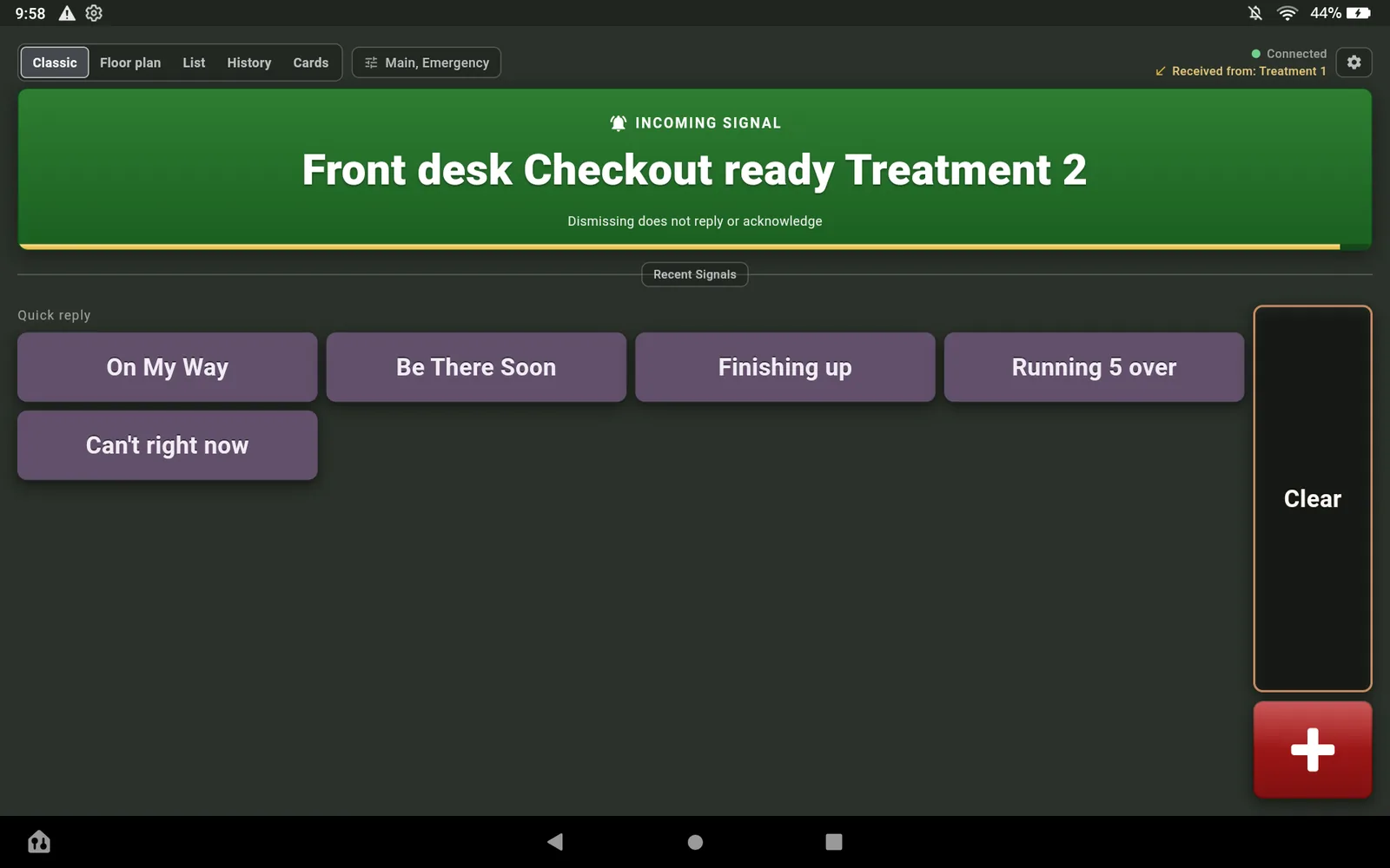 The Fire HD 10 in Spa Dim showing the incoming signal Front desk Checkout ready Treatment 2 above the quick replies.